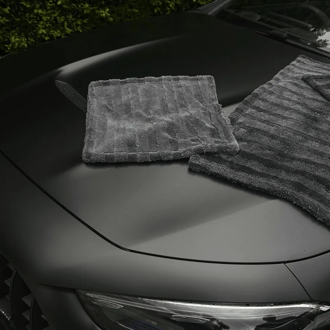 Two gray car drying towel on a black car hood - by The Fox Tail