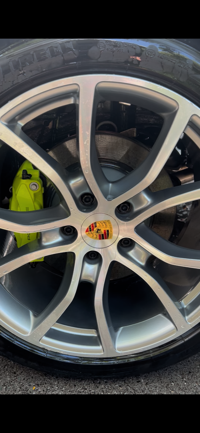 A clean, finished car wheel after using The Fox Tail wheel detailing mitt