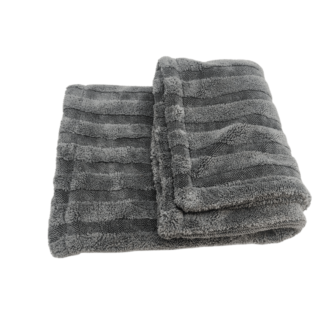 Folded gray premium plush car detailing drying towel on a white background