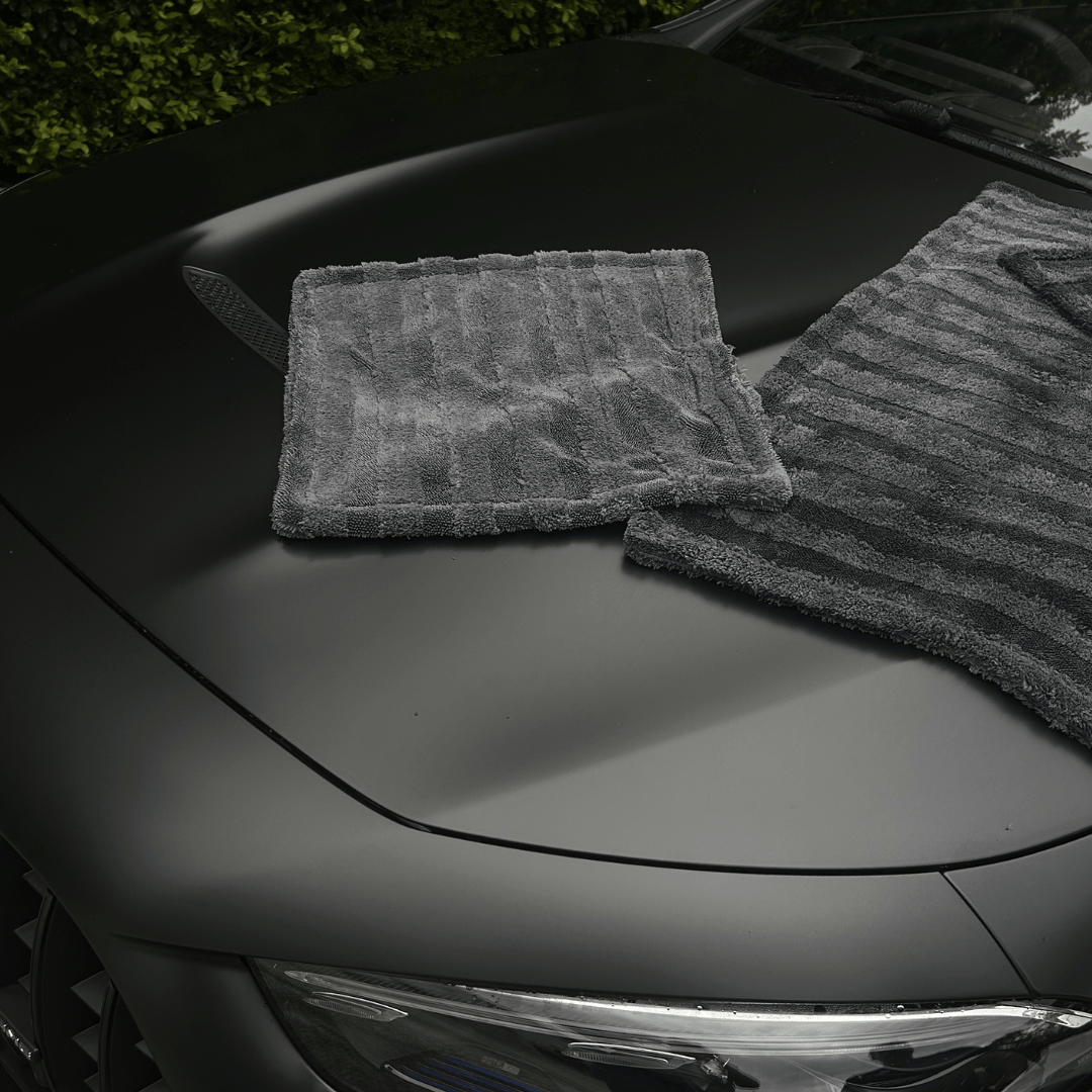 Two gray car drying towel on a black car hood - by The Fox Tail