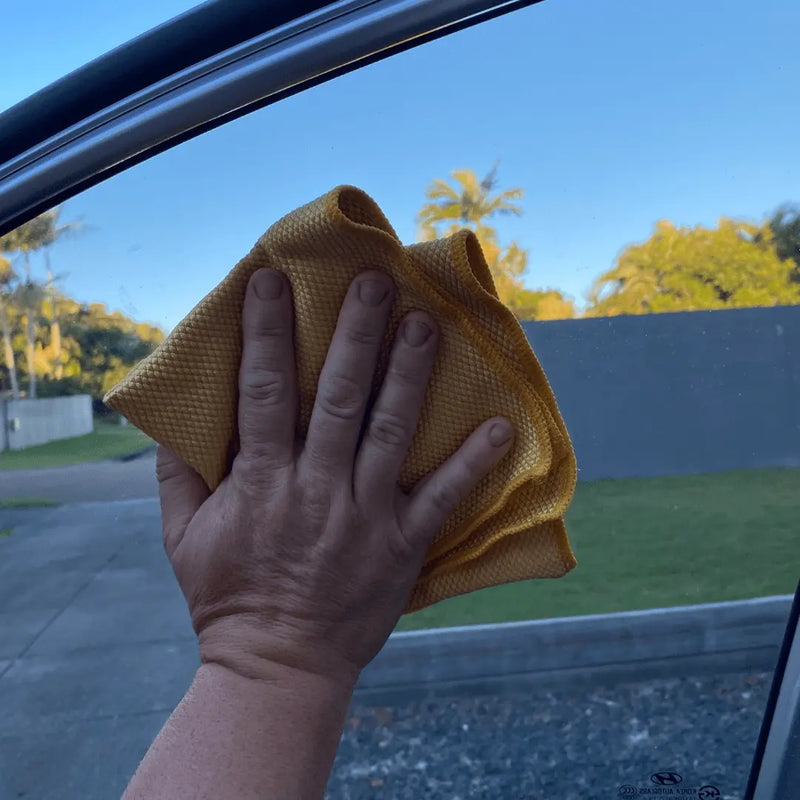 Fox Tail glass towel, pro detailer glass cleaning towel. showcased drying a car window