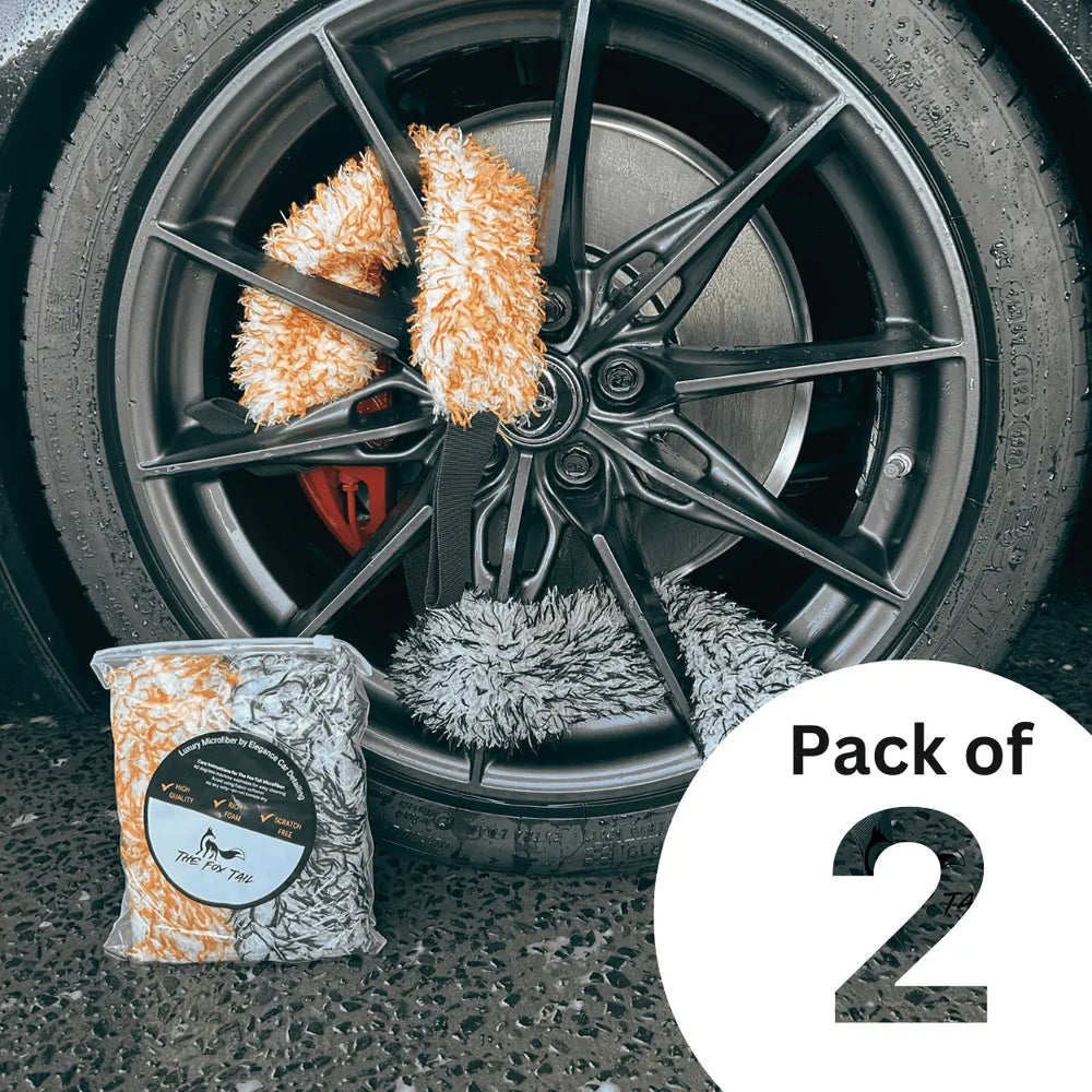 The Fox Tail wheel detailing mitt pack of two on a car rim