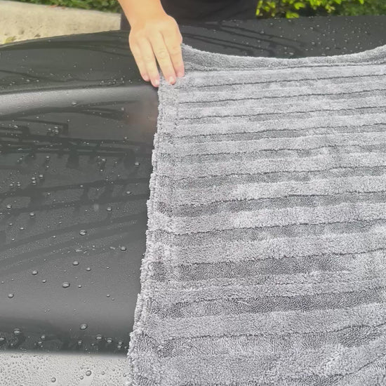 video of premium quality car detailing drying towel showcased to dry a black car hood - by the Fox Tail